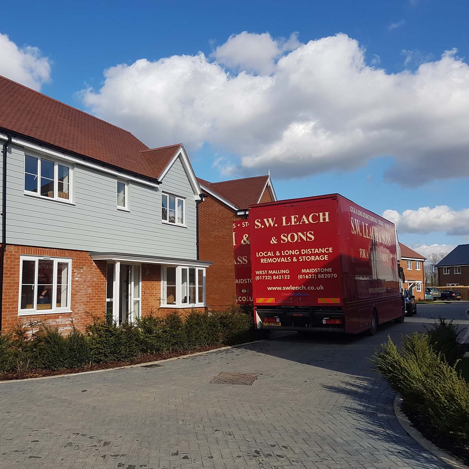 home removals - sw leach van parked in front of a house